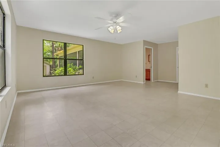 Tiled spare room with ceiling fan