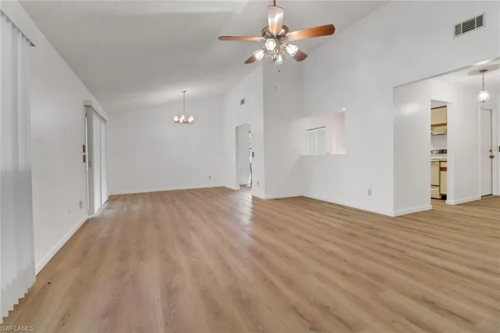 Living room with light hardwood / wood-style floors, ceiling fan