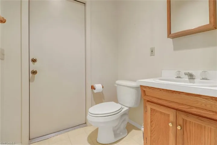 Bathroom with vanity, toilet, and tile patterned floors