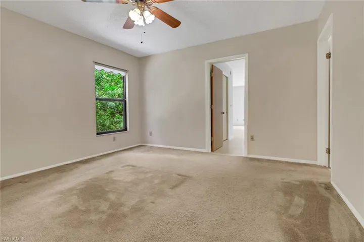 Spare room with light colored carpet and ceiling fan