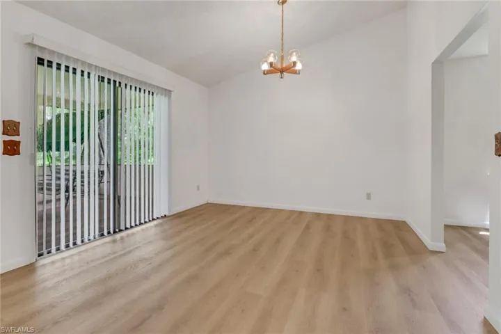 Dining area, vaulted ceiling, and light wood-type flooring