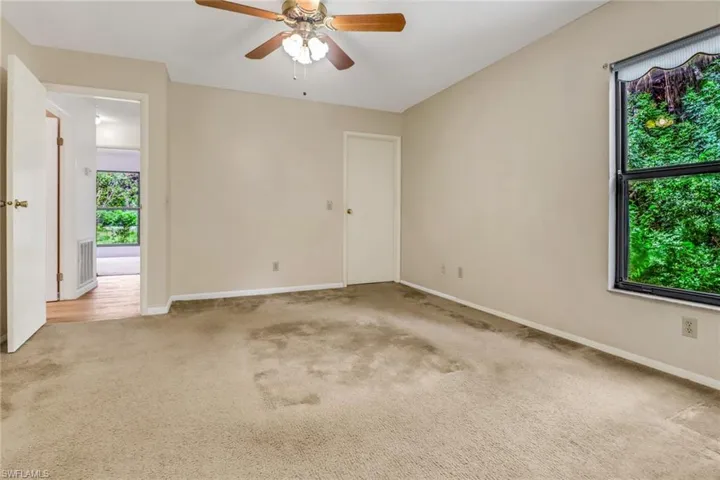 Spare room with light carpet and ceiling fan