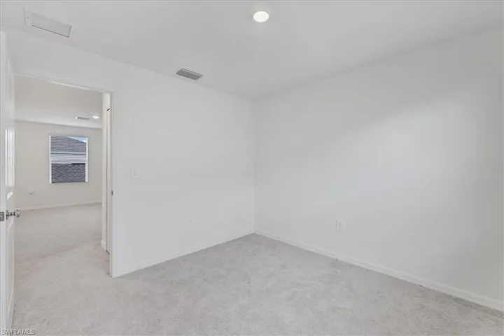 Spare room with light carpet and recessed lighting