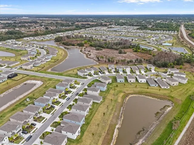 View of property location with a large body of water and nearby suburban area