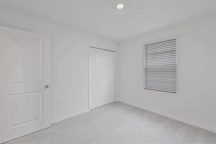 Unfurnished bedroom with carpet and a closet
