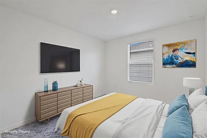 Bedroom featuring carpet floors and baseboards