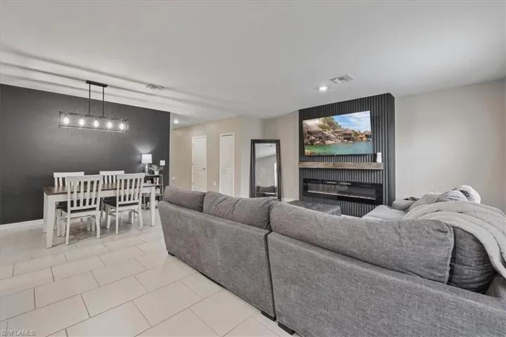 Living area featuring light tile patterned floors and recessed lighting