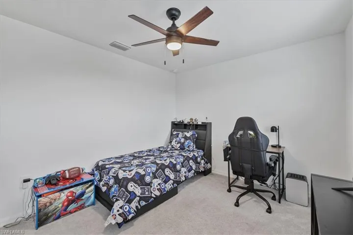 Bedroom with carpet floors and a ceiling fan