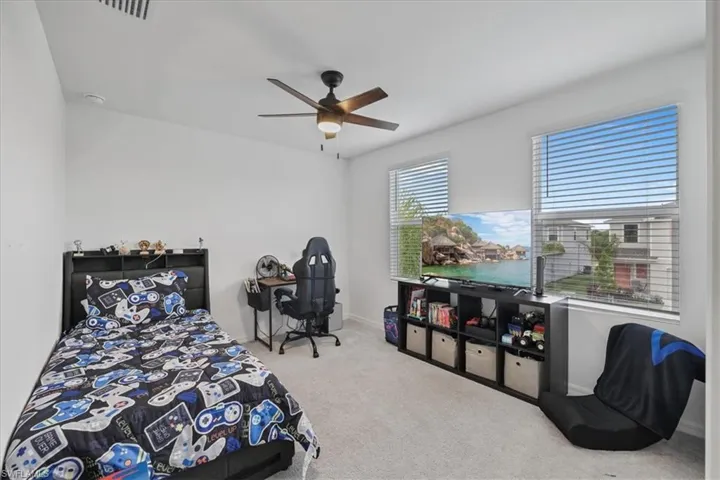 Bedroom with carpet and ceiling fan