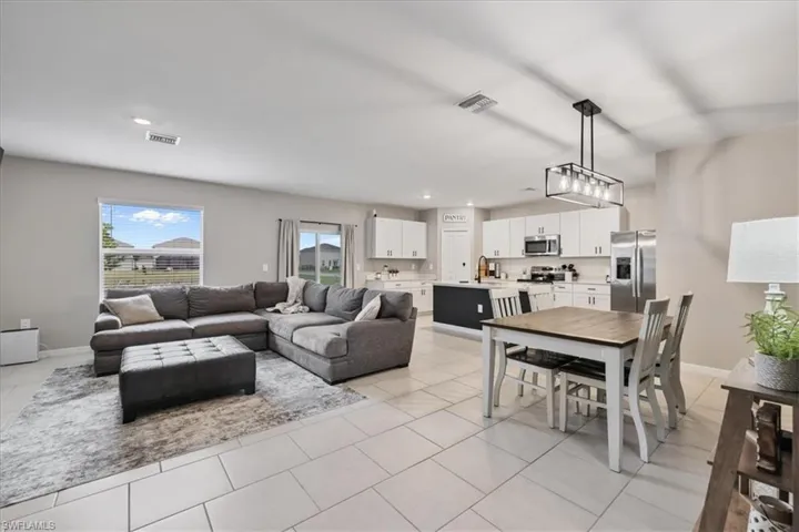 Living room with recessed lighting and light tile patterned floors