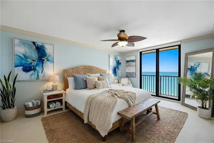 Bedroom with a water view, ornamental molding, access to outside, a ceiling fan, and carpet floors