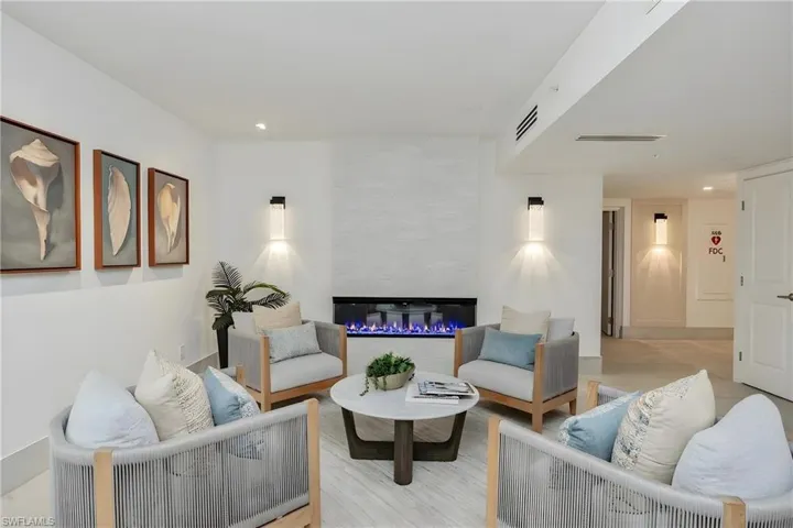 Living room with recessed lighting, light wood finished floors, and a fireplace