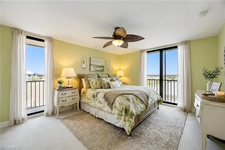 Bedroom with access to exterior, carpet flooring, and a ceiling fan