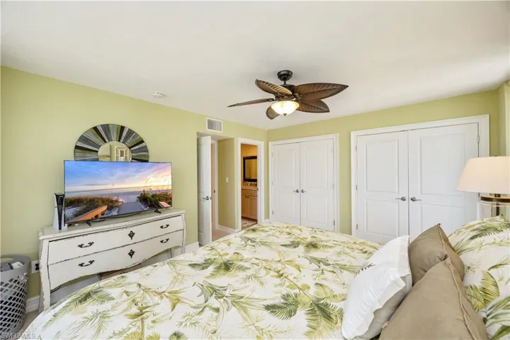 Bedroom featuring multiple closets and ceiling fan