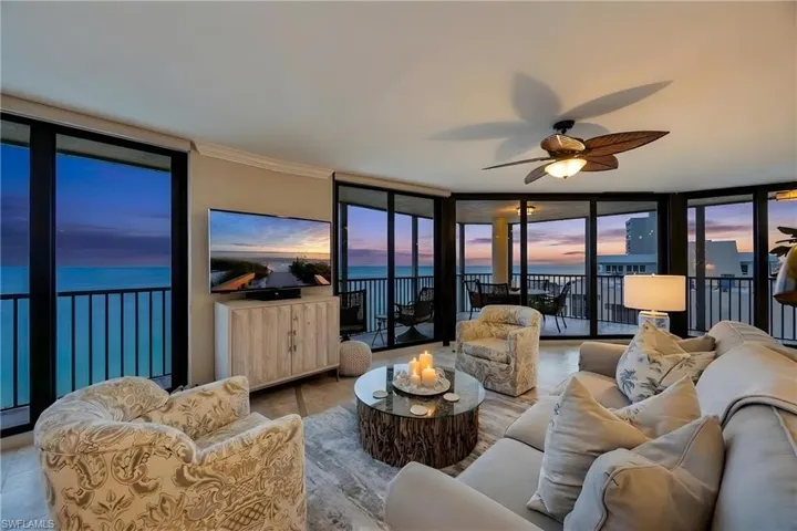 Living room with expansive windows and a ceiling fan