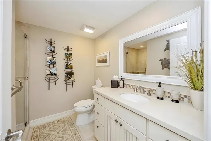 Bathroom with vanity, a shower stall, and light tile patterned flooring