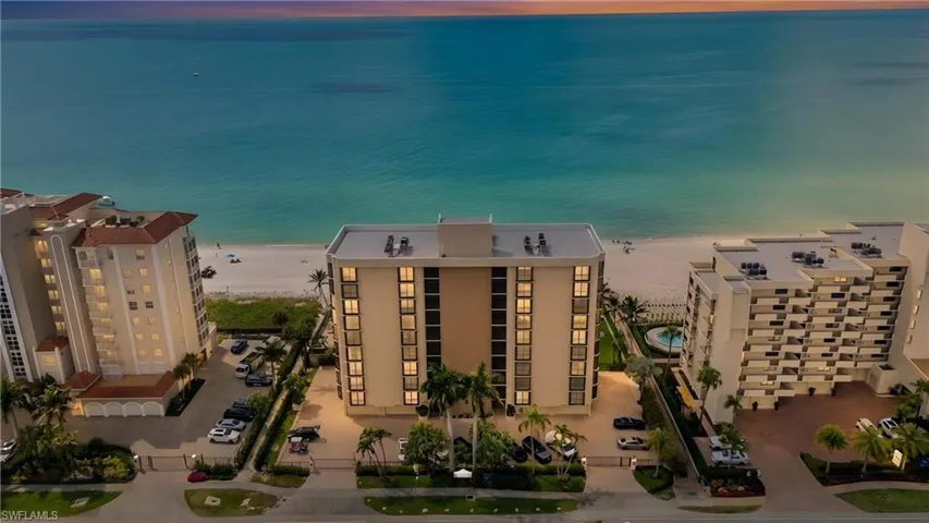 Aerial view of unending shoreline and apartment complex / building
