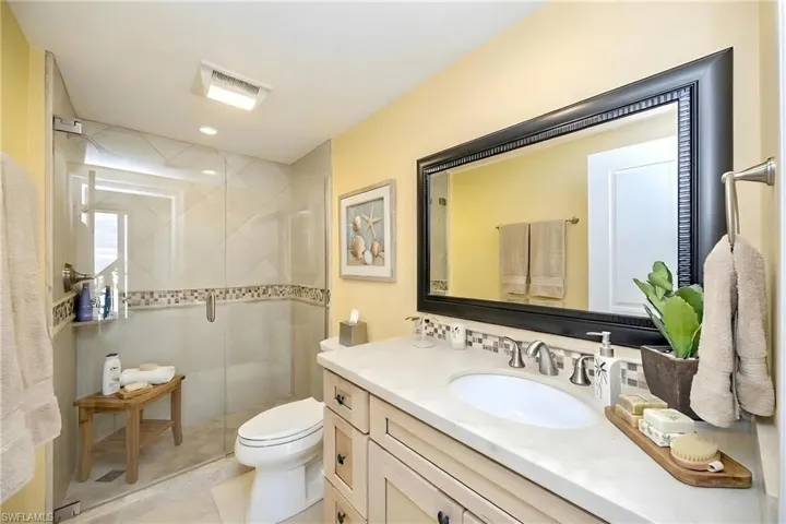 Full bathroom featuring vanity and a stall shower