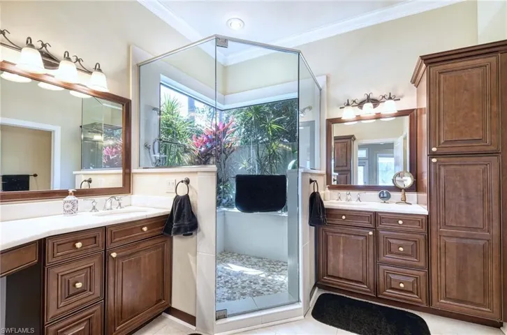 Corner Shower, new luxury flooring, crown molding, and built-in linen closet.