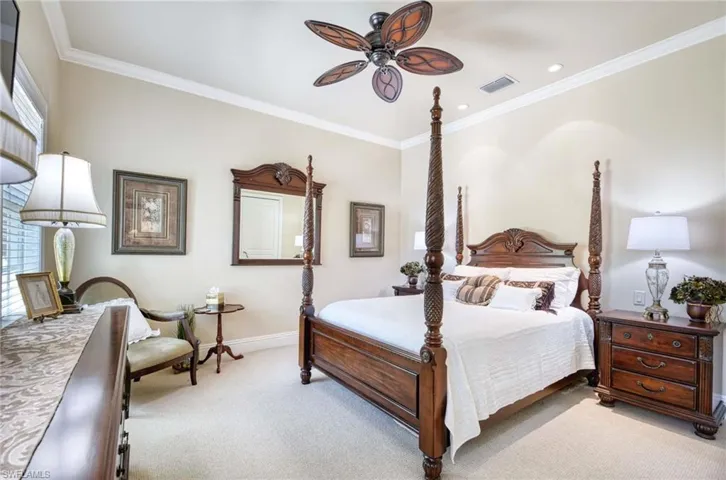 Crown molding, ceiling fan, and oversized double closet.