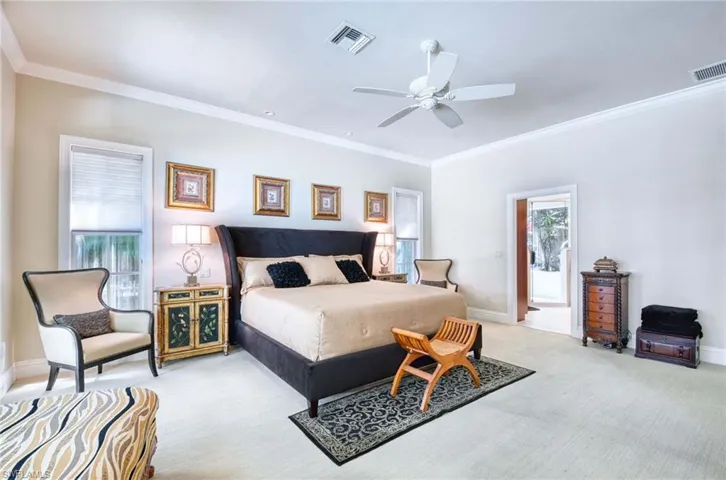 Primary Bedroom, Spacious and warm with crown molding, ceiling fan and two closets.