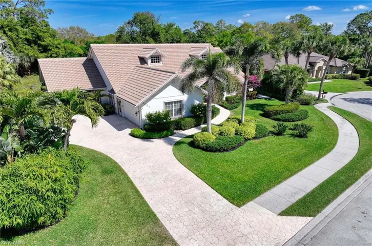 View of front of home with front yard, patterned concrete driveway, a new tile roof in 2023, and stucco siding