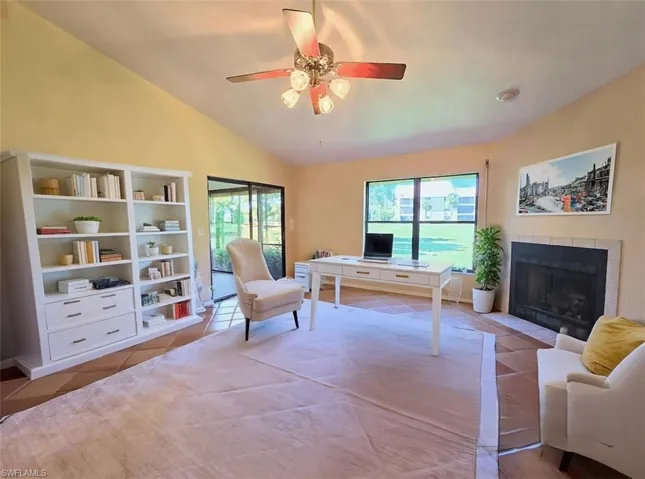 VIRTUALLY STAGED Den w/White Modern Furniture set up as a Home Office w/Fireplace & Sliders -View 2