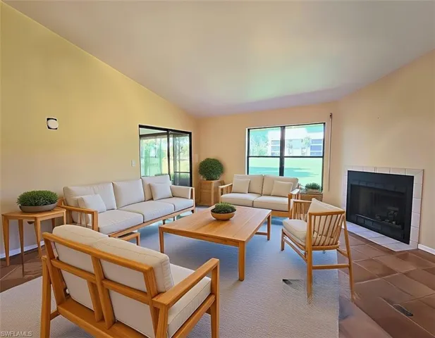 VIRTUALLY STAGED Den w/Scandinavian Furniture w/Fireplace & Sliders facing Lanai & Golf Course