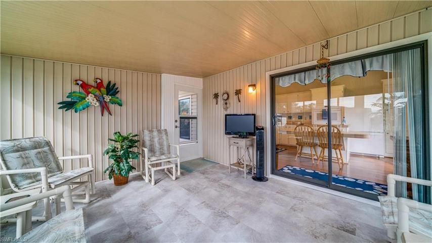 Just a step from the kitchen, there's much room on this lanai for coffee, cocktails, and/or dining. Look at that COREtec LVT floor!