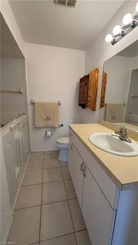 Primary bathroom features a walk-in bathtub.