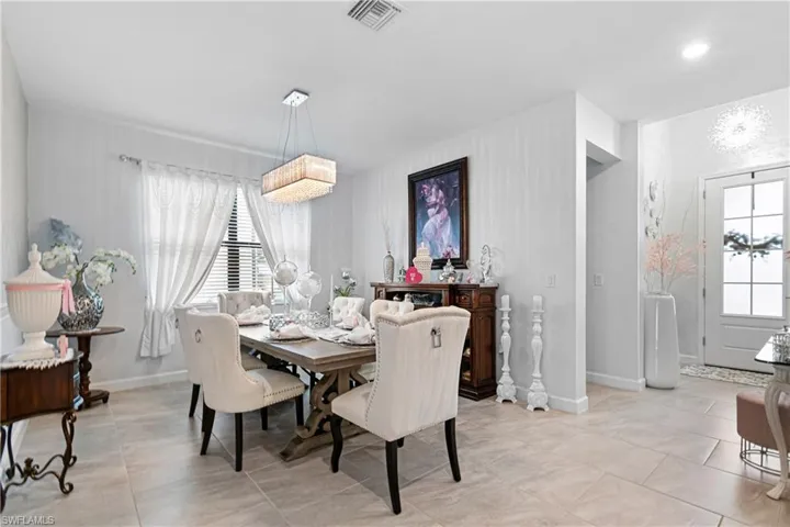 Dining space with a chandelier and light tile patterned floors