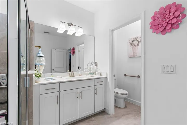 Full bathroom with vanity and tile patterned flooring