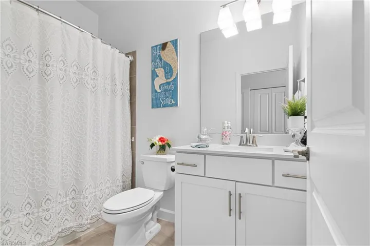 Bathroom featuring vanity and a shower with shower curtain