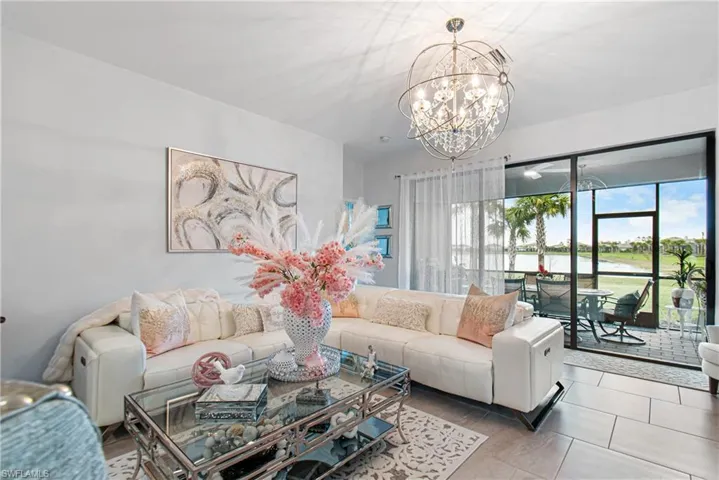 Tiled living area with a water view and a chandelier