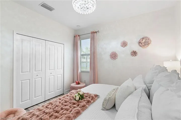 Bedroom with wood finished floors and a closet
