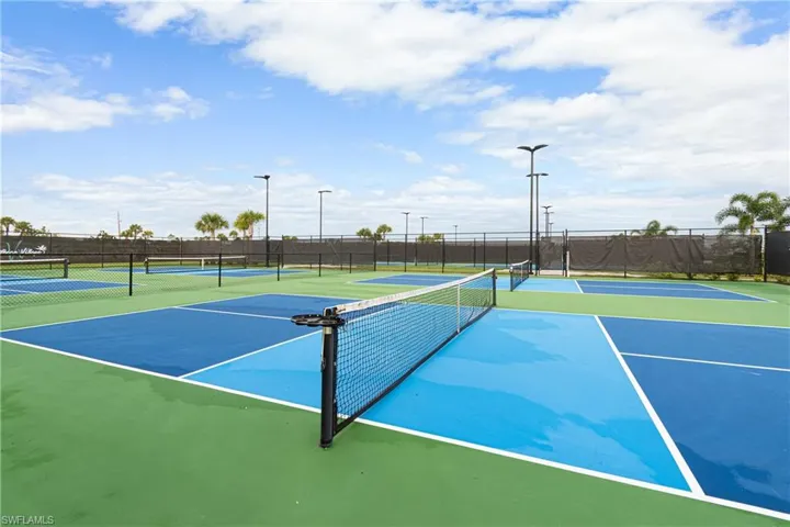 View of tennis court with community basketball court