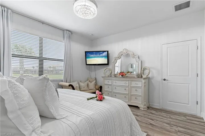 Bedroom featuring light wood-style flooring and baseboards