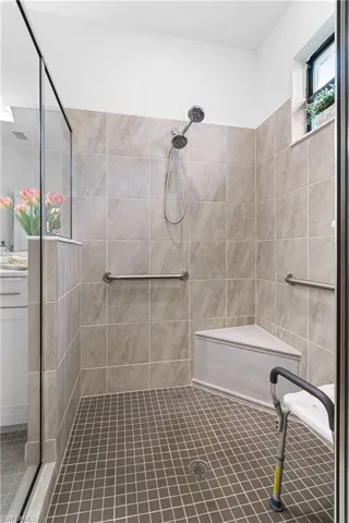 Full bath featuring tiled shower