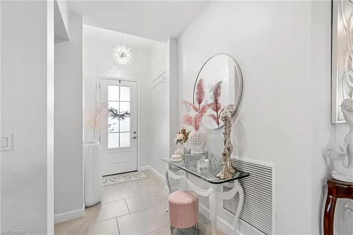 Entryway with a chandelier and light tile patterned floors