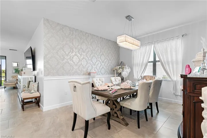 Dining area with wallpapered walls and wainscoting