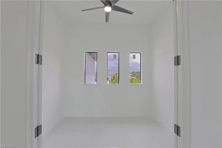 Empty room featuring baseboards and ceiling fan