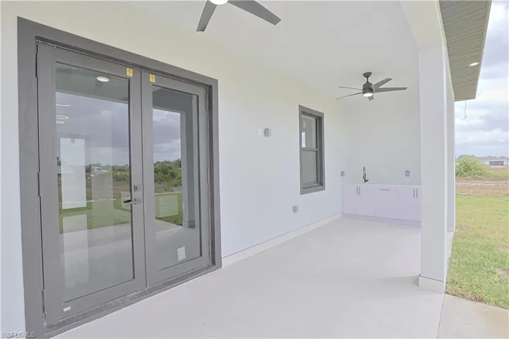 View of patio featuring french doors and a ceiling fan