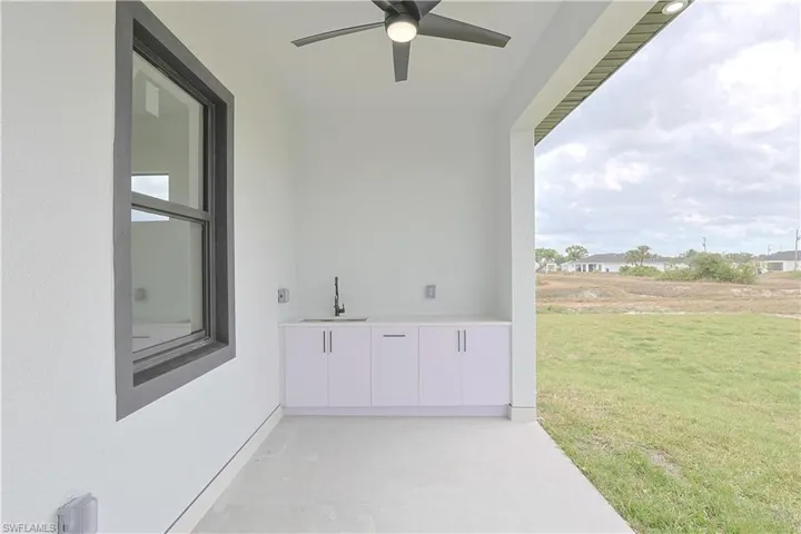 View of patio / terrace featuring a ceiling fan and a sink