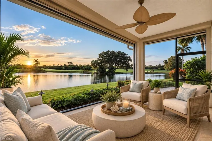 Golf Course and Long Water Views! Virtually Staged Expansive screened patio featuring large format sliding glass doors, a ceiling fan, and direct water frontage
