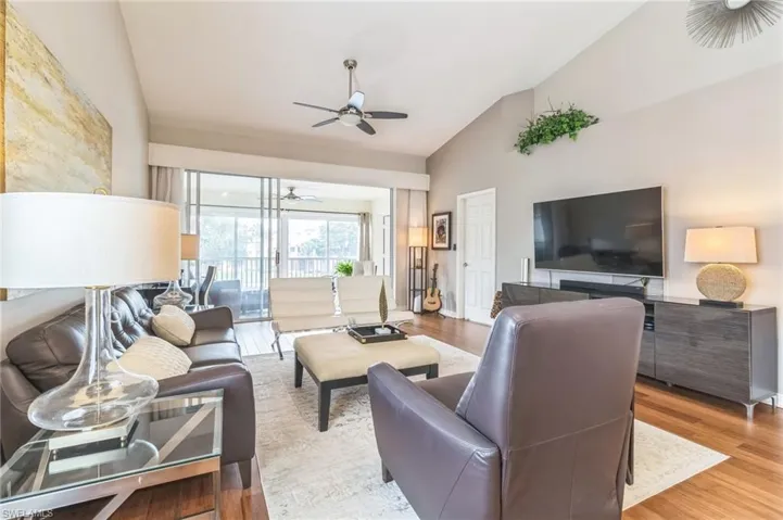 Vaulted ceilings, neutral colors, and wood flooring create an elegant living space.