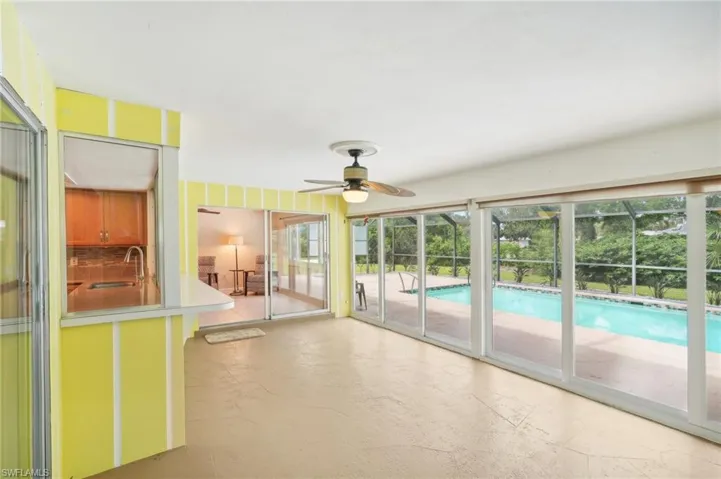 Pass through window from kitchen, sliders to family room and sliders to extra large 30 x 20 pool  and 7' - 4' deep pool.