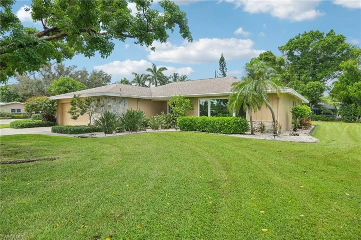 Single story home featuring a 2 car garage and a front yard
