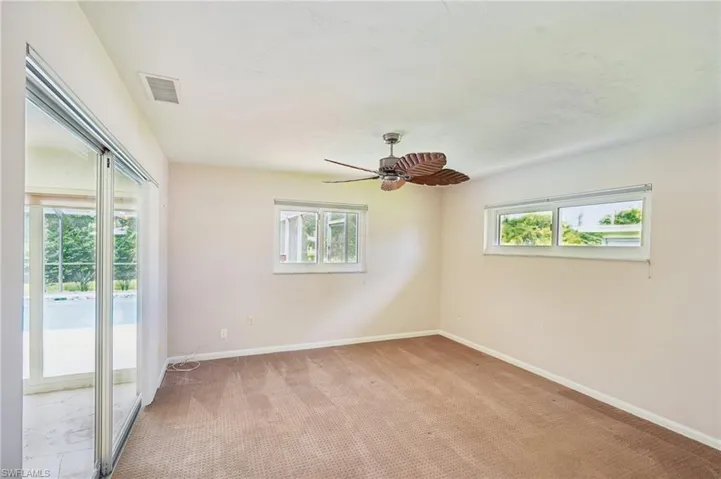 2 guest bedroom with sliding doors to Florida room and screened lanai and pool area!