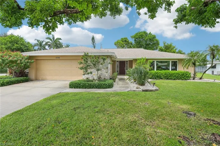 Single story home featuring a 2 car garage and a front yard