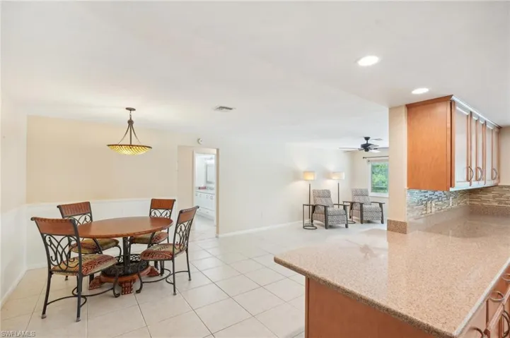 Breakfast area and kitchen bar with view of family room.